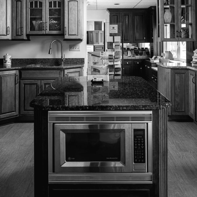 Black and white photo of a kitchen.