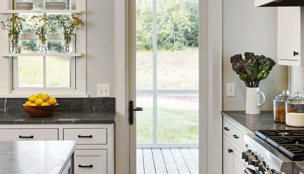 View of an inside kitchen door leading outside onto a porch.