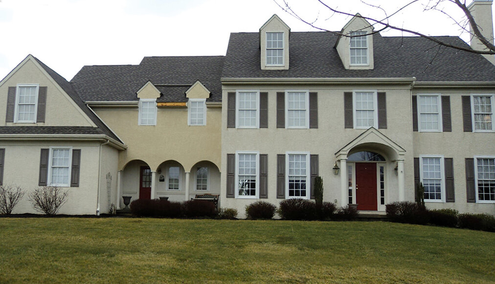 Outside view of a home before stucco remediation