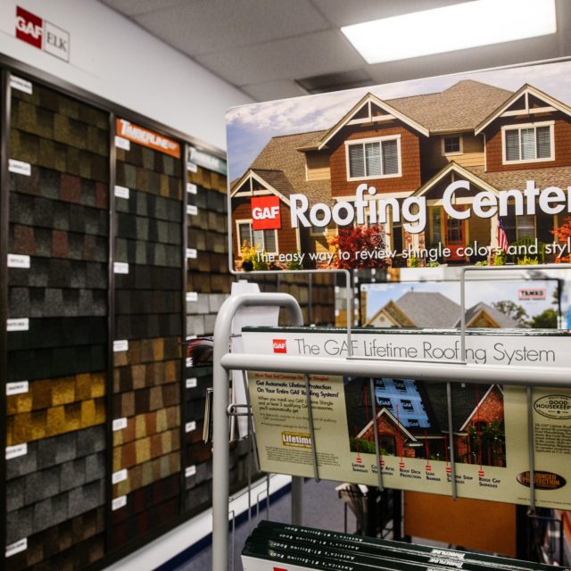 Roofing center display inside J&L showroom.