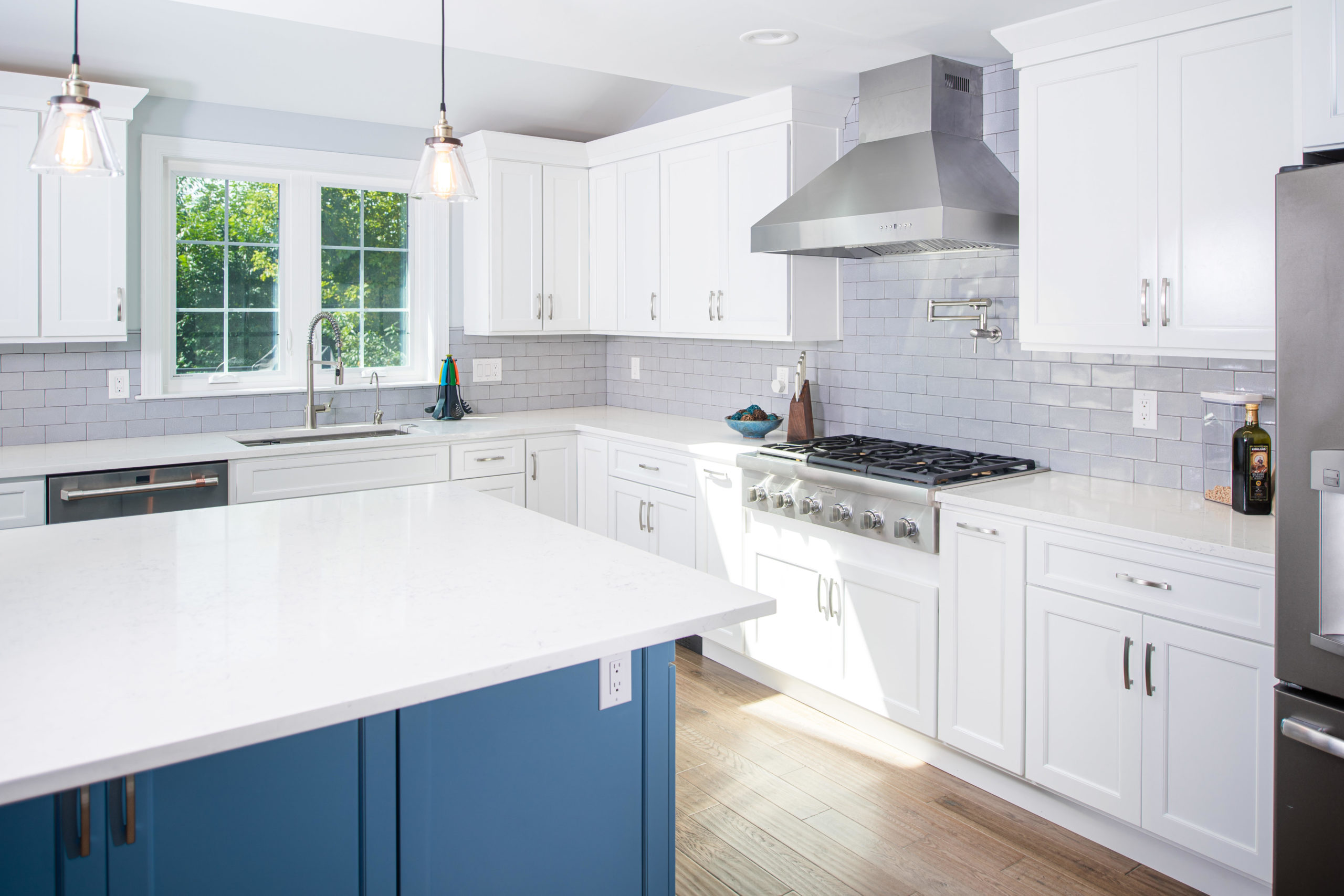 Modern white and blue kitchen with an island.