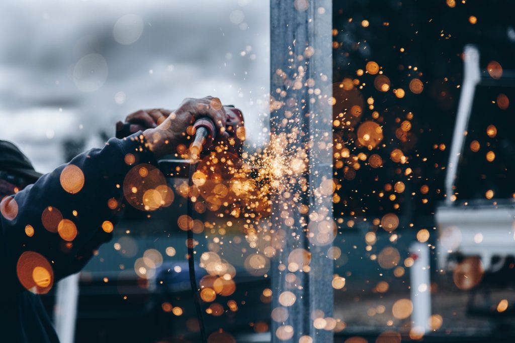 Close up picture of a man welding.