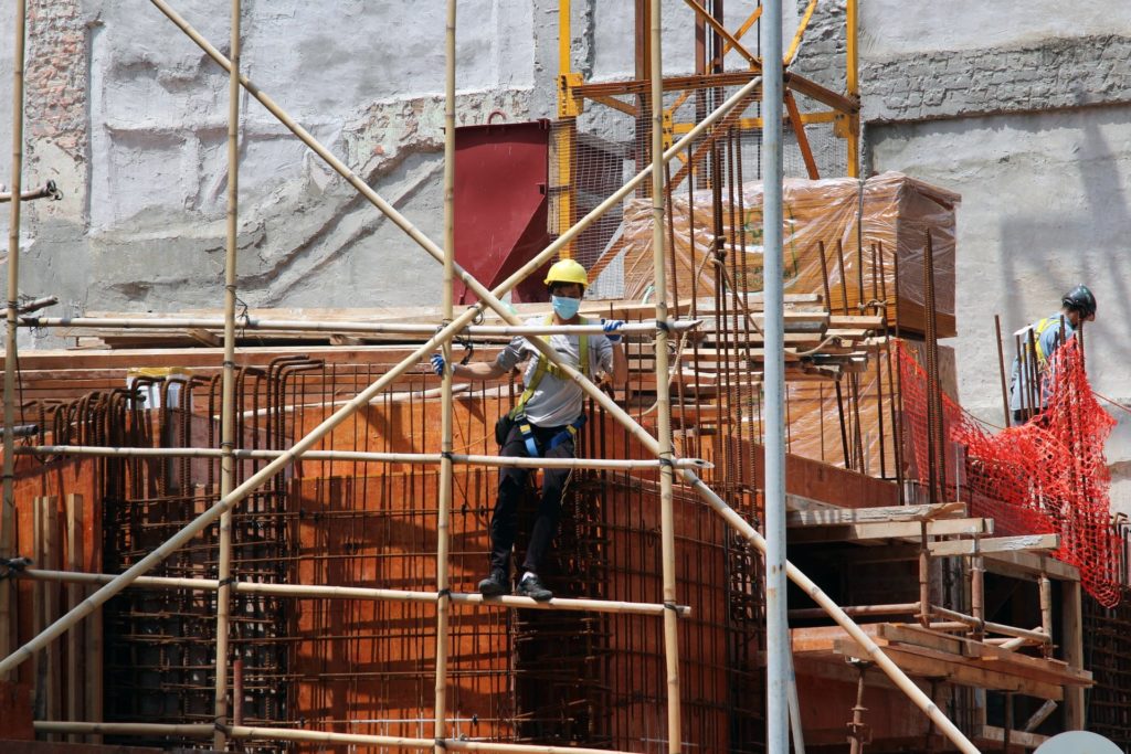 Picture of a construction worker on a high rise.