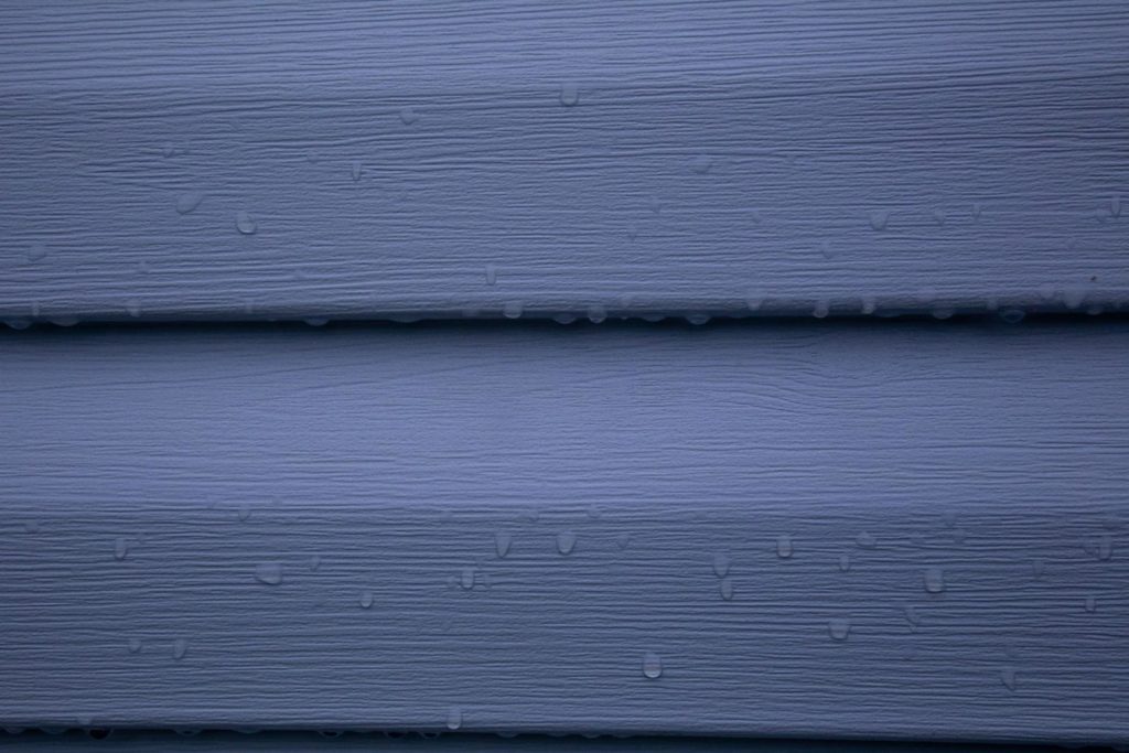 A close-up picture of blue vinyl siding.