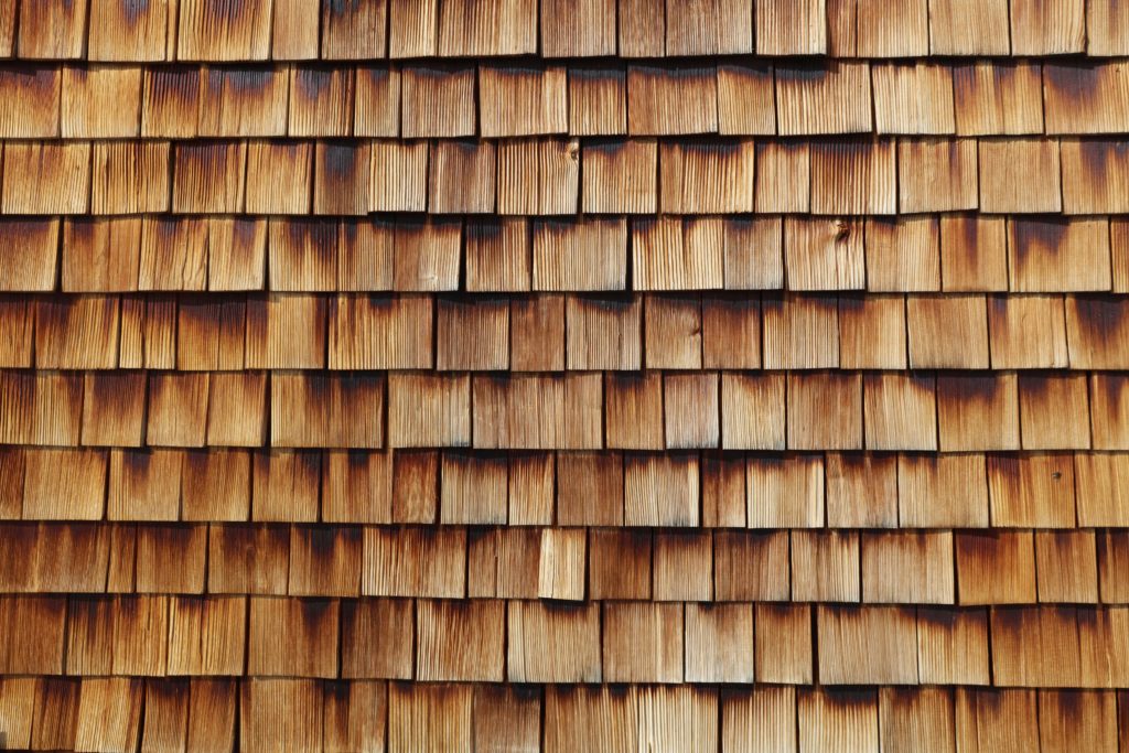 An up-close photo of wood shingle siding.