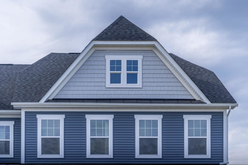 A picture of an A-frame building with single hung windows.