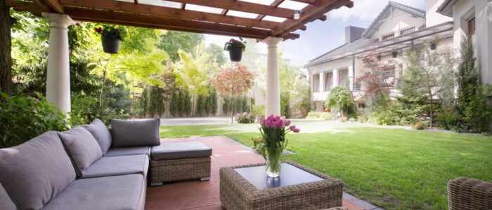 A raised deck outside with a sofa and coffee table.