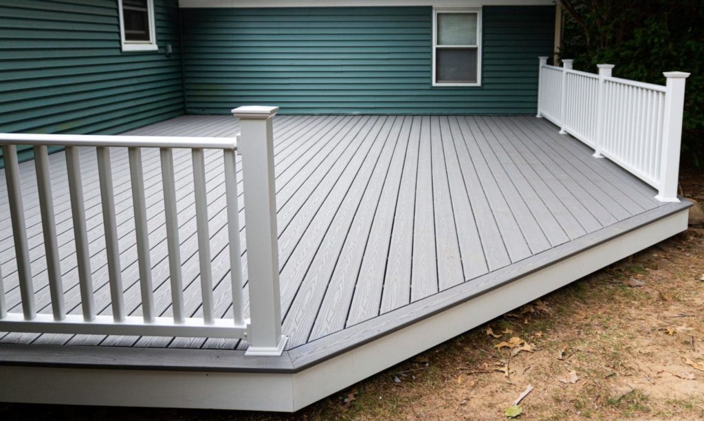A picture of a platform deck with teal vinyl siding. 