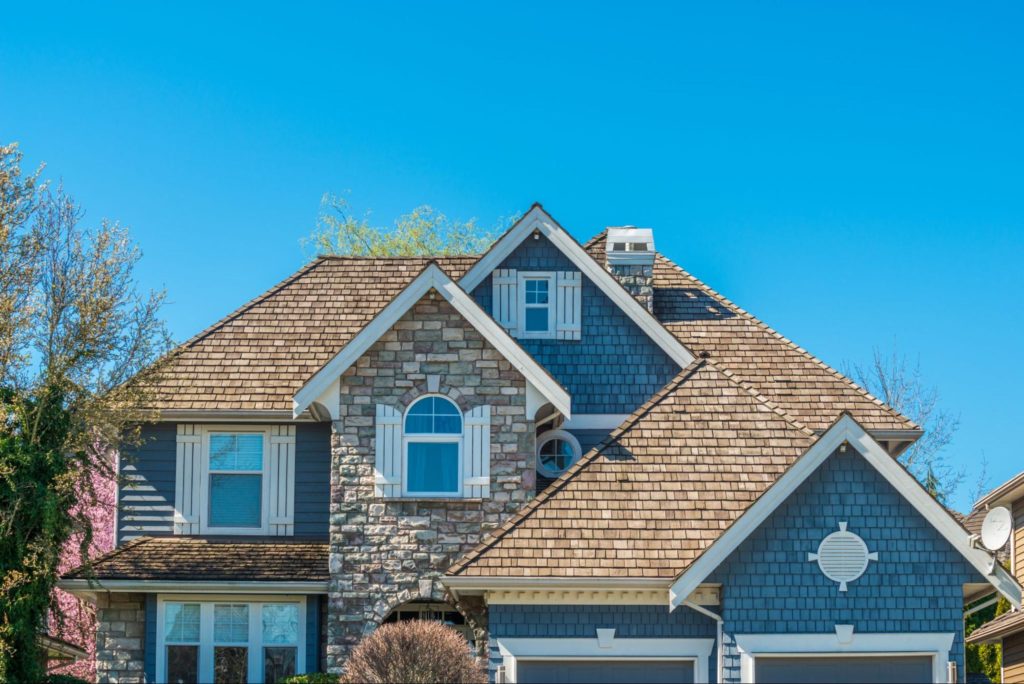 A picture of a roof with wood shingles.