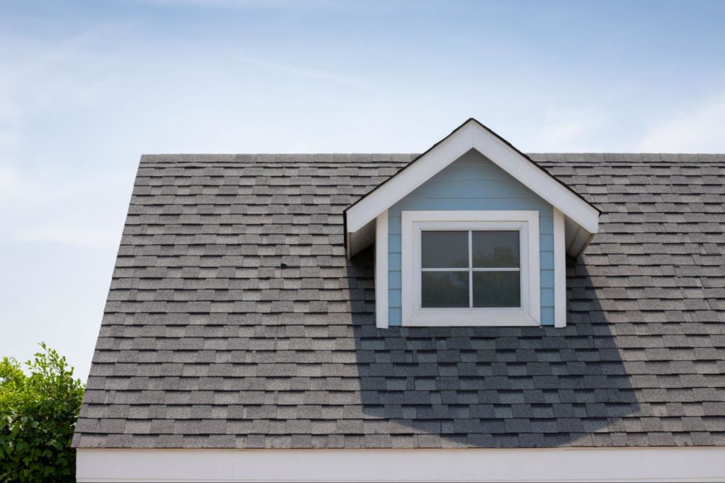 A picture of a roof with asphalt shingles.