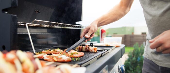 A man grilling outdoors.