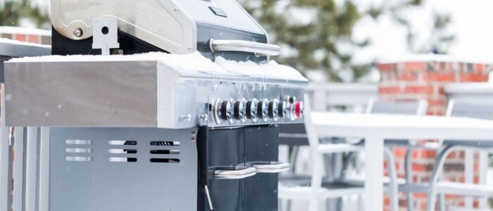 A grill outside in the snow.