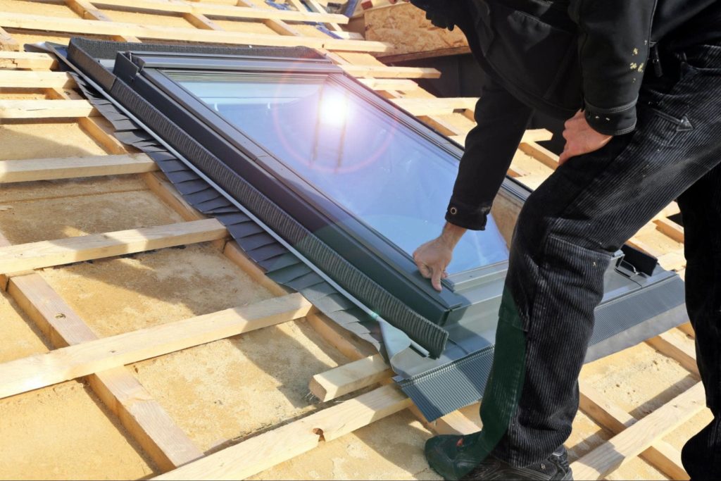 Contractor on a roof installing a skylight.