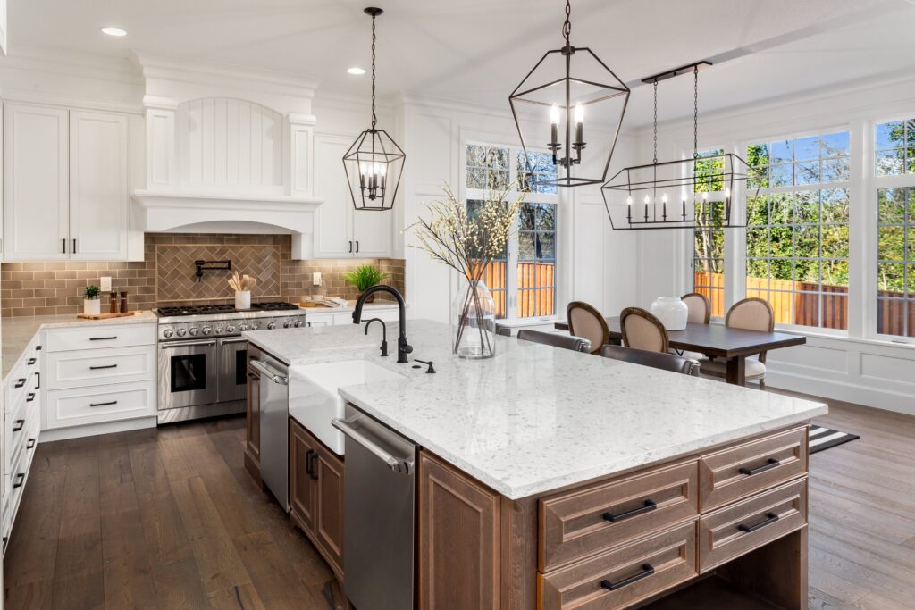 A traditional kitchen design with granite coutnertops and a mix of white and wood cabinets.