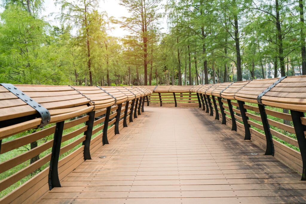 An image of curved wooden railings on a deck path.