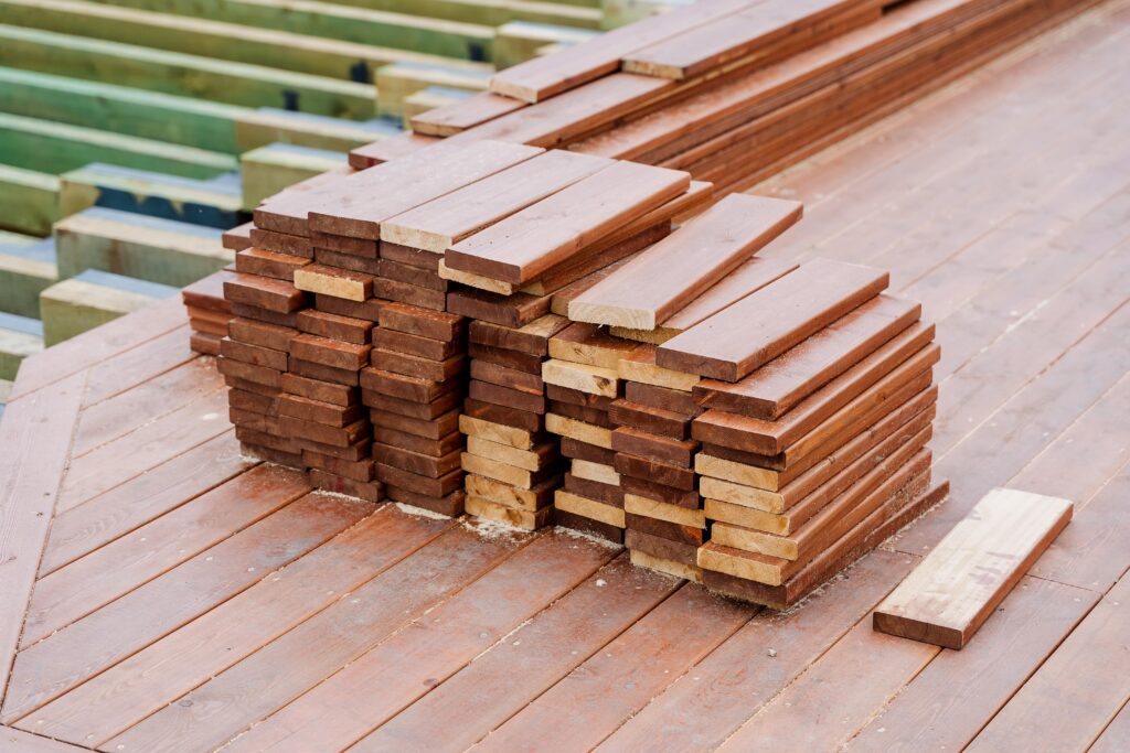 A neat pile of cut deck boards on a deck.