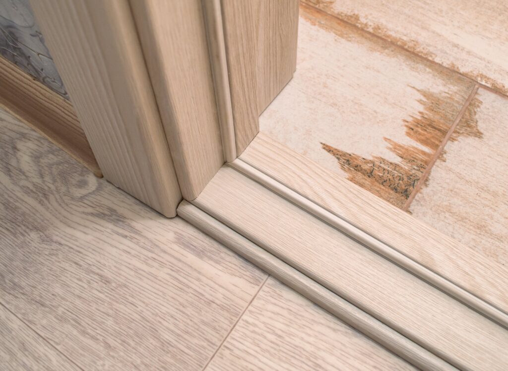 A wood door sill with a wooden door frame.