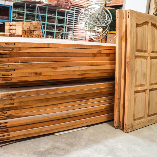 A stack of doors in a storeroom.