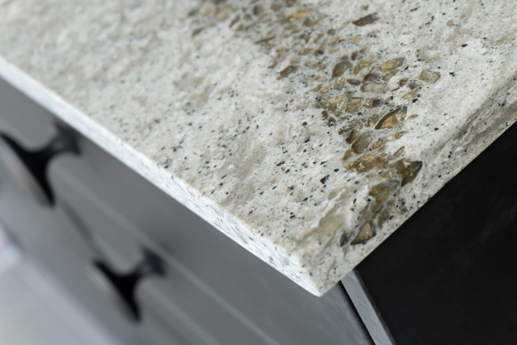 An image of the corner of a quartz kitchen countertop with black cabinets.