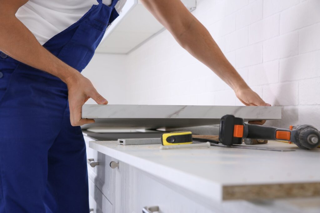 An image of someone installing a kitchen countertop.