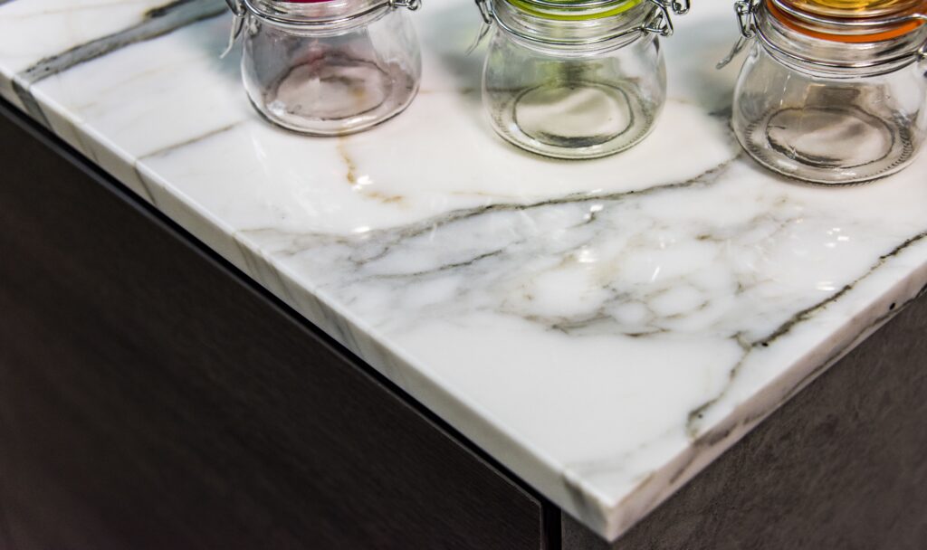 An image of a marble countertop with three jars on top.