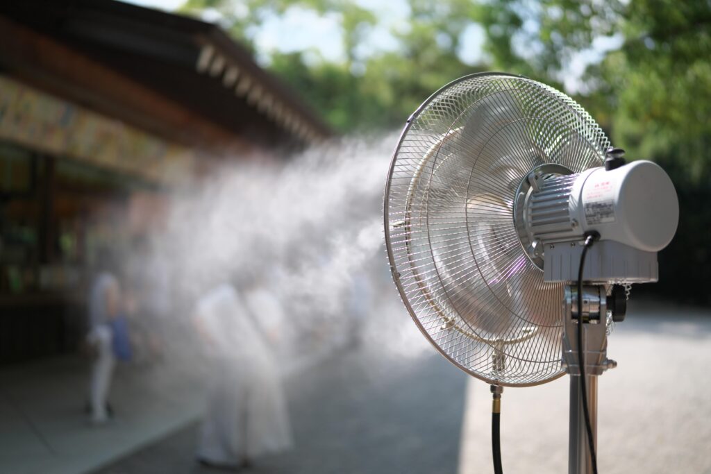 A misting standing fan running on a warm day.