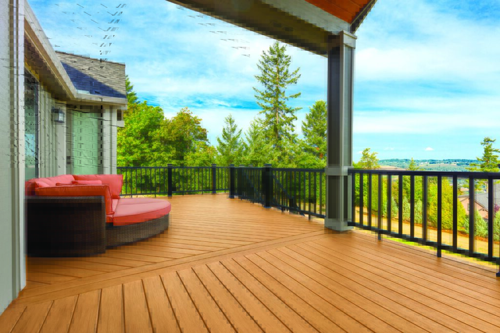 A composite decking overlooking a valley with a patio furniture on it.