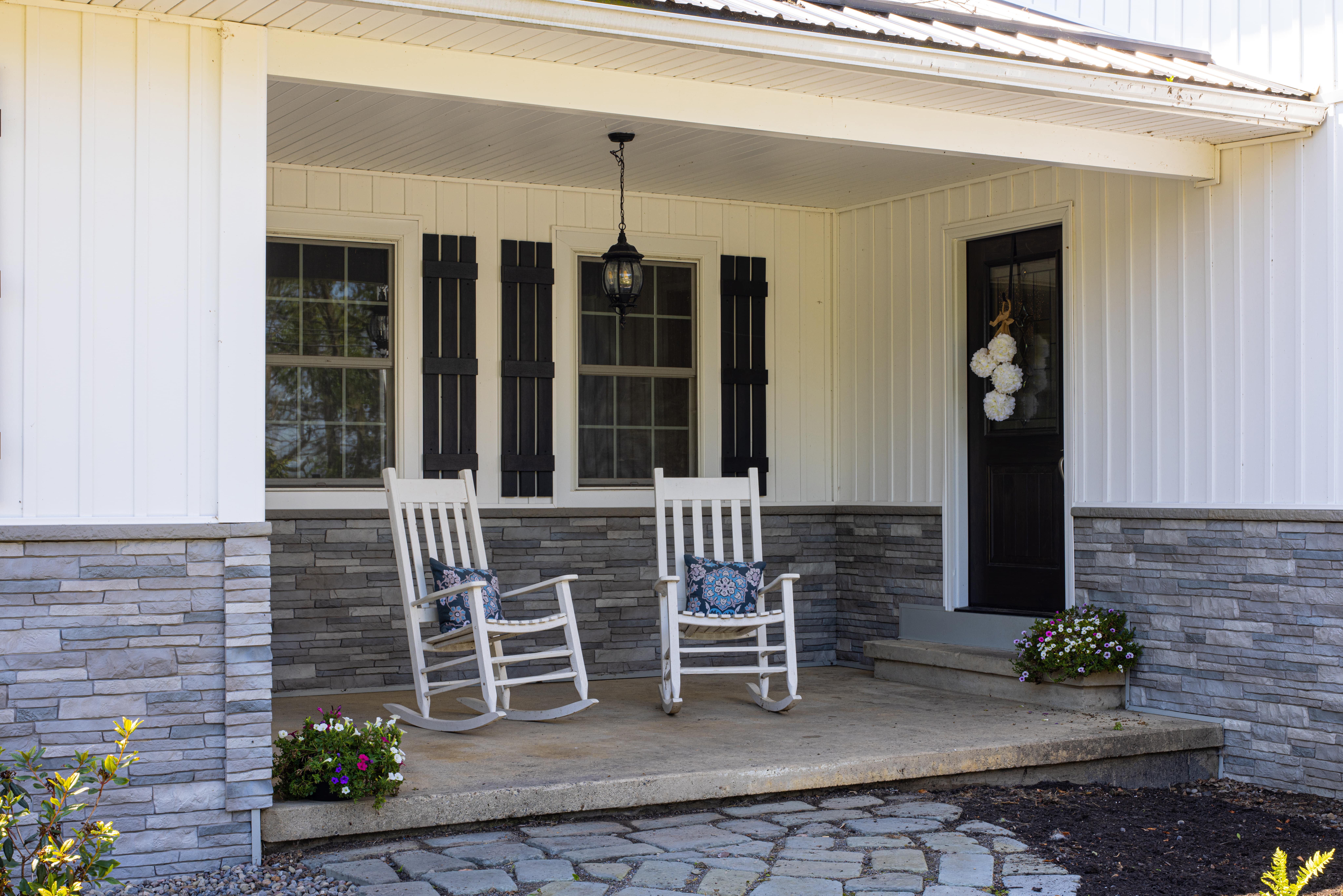 Tando Stone Composite on the entry way of a house with rocking chairs out front