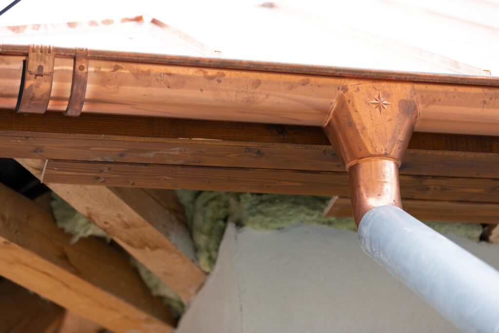 A copper gutter on the outside of a home
