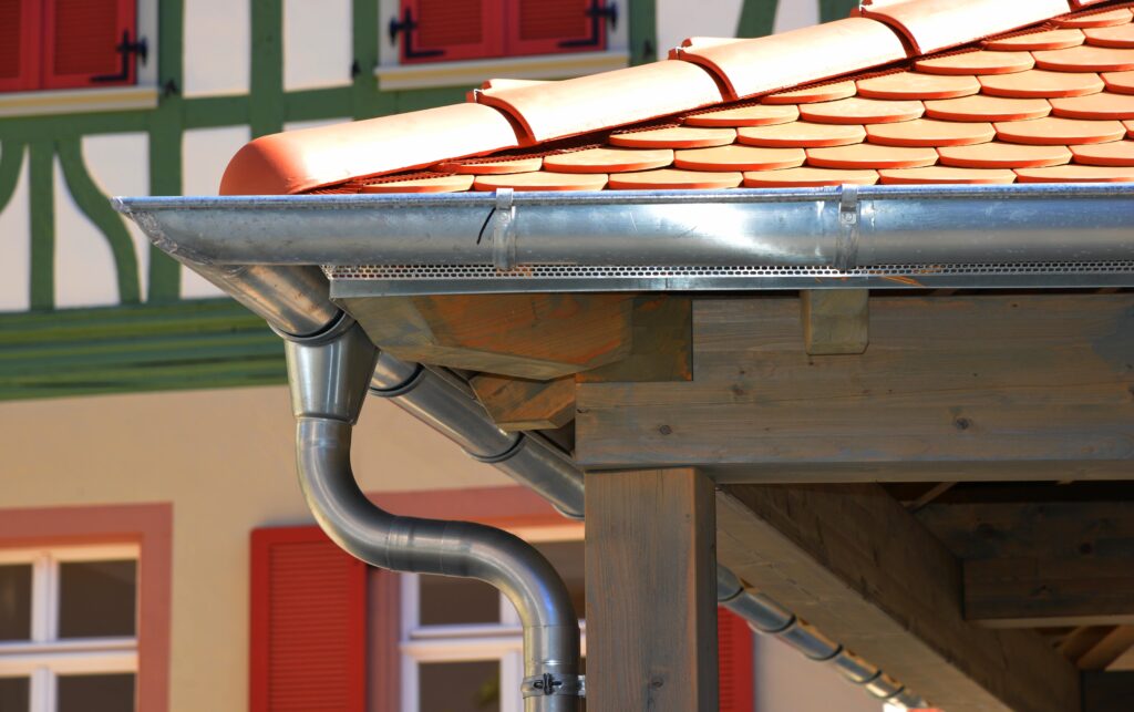 A terracotta roof with steel rain gutters