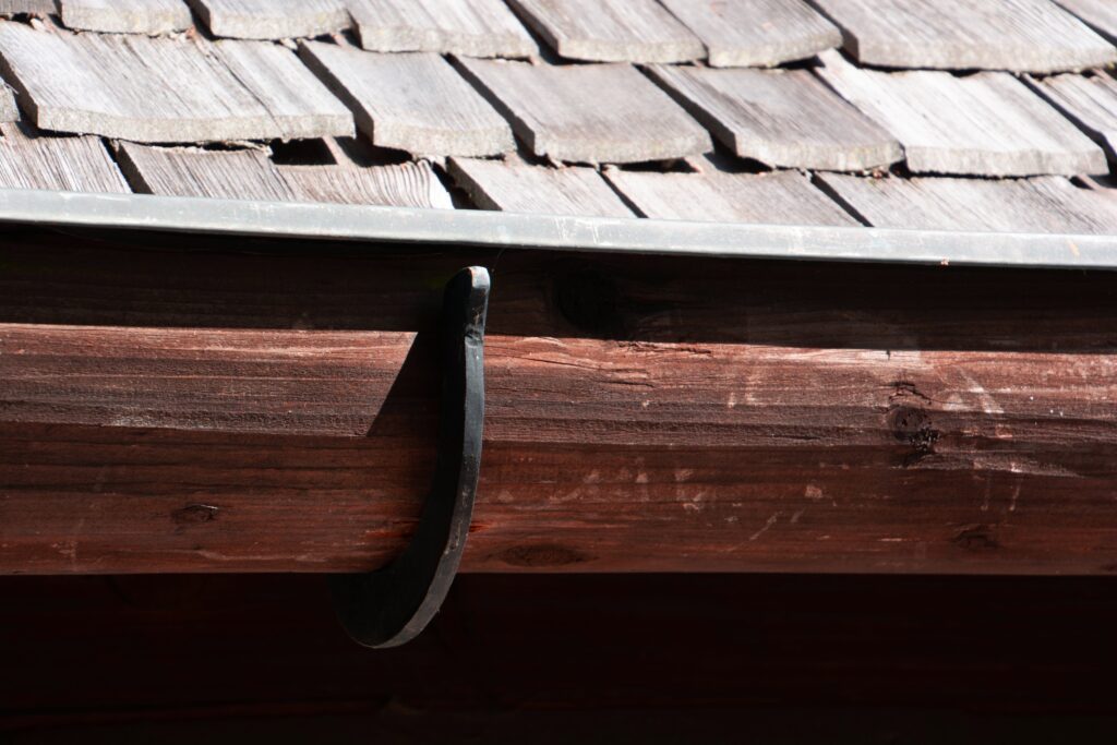 A wood gutter attached to a wooden roof